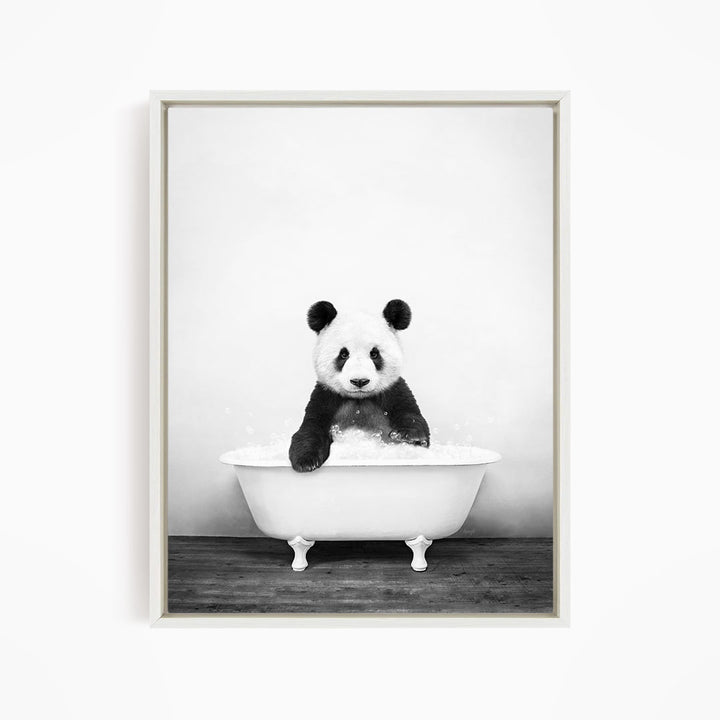 A panda bear sitting in a white bathtub filled with bubbles, creating a whimsical and playful scene.