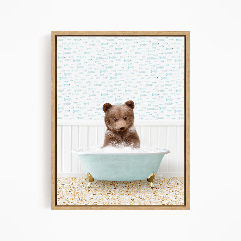 A cute brown bear sitting in a light blue bathtub filled with water, surrounded by a patterned wallpaper.