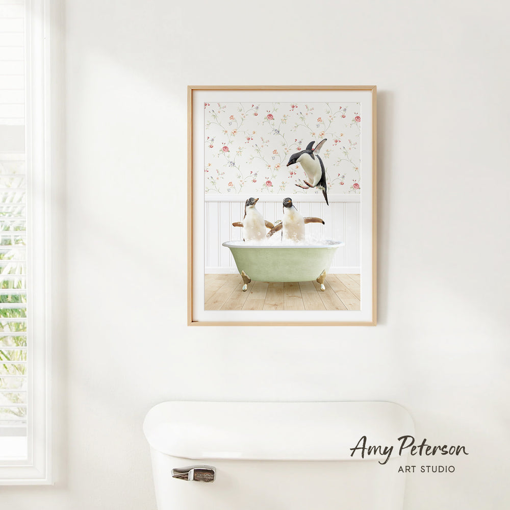 A framed image of two penguins sitting in a bathtub, with one penguin standing on the edge of the tub.
