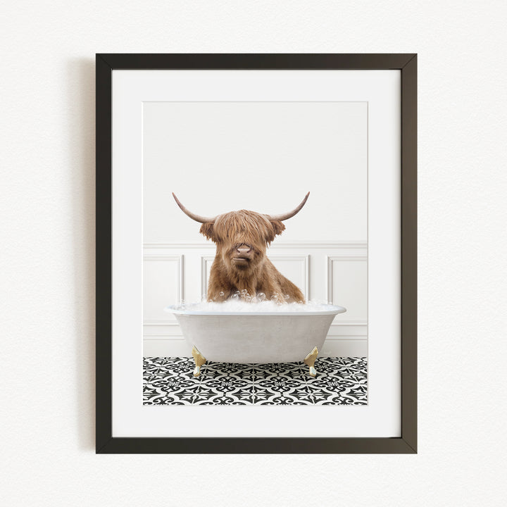 A Highland cow with long horns is sitting in a white bathtub filled with water, creating a whimsical and playful scene.