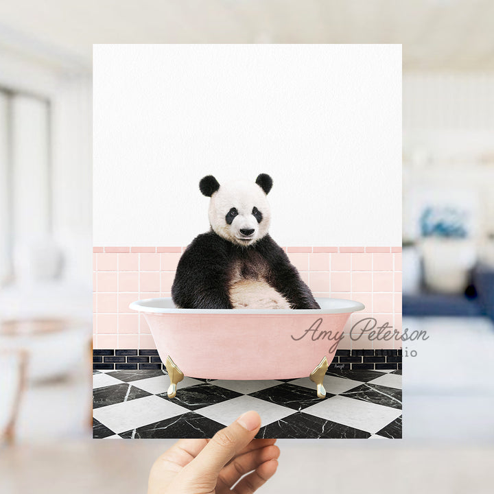 a panda bear sitting in a pink bath tub