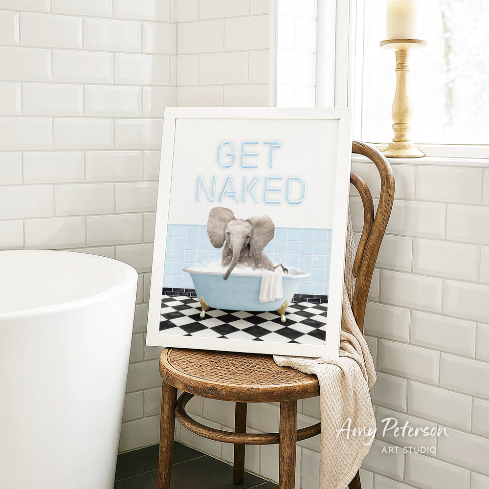 A framed image of an elephant sitting in a bathtub, with the text "GET NAKED" displayed on the frame.