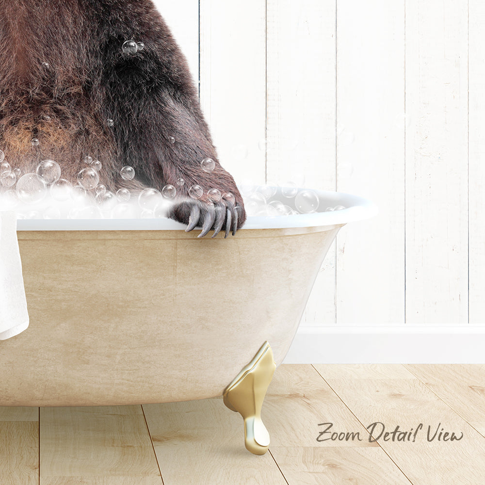 A close-up of a bear's paw in a bathtub filled with bubbles, with a wooden floor and white wall in the background.