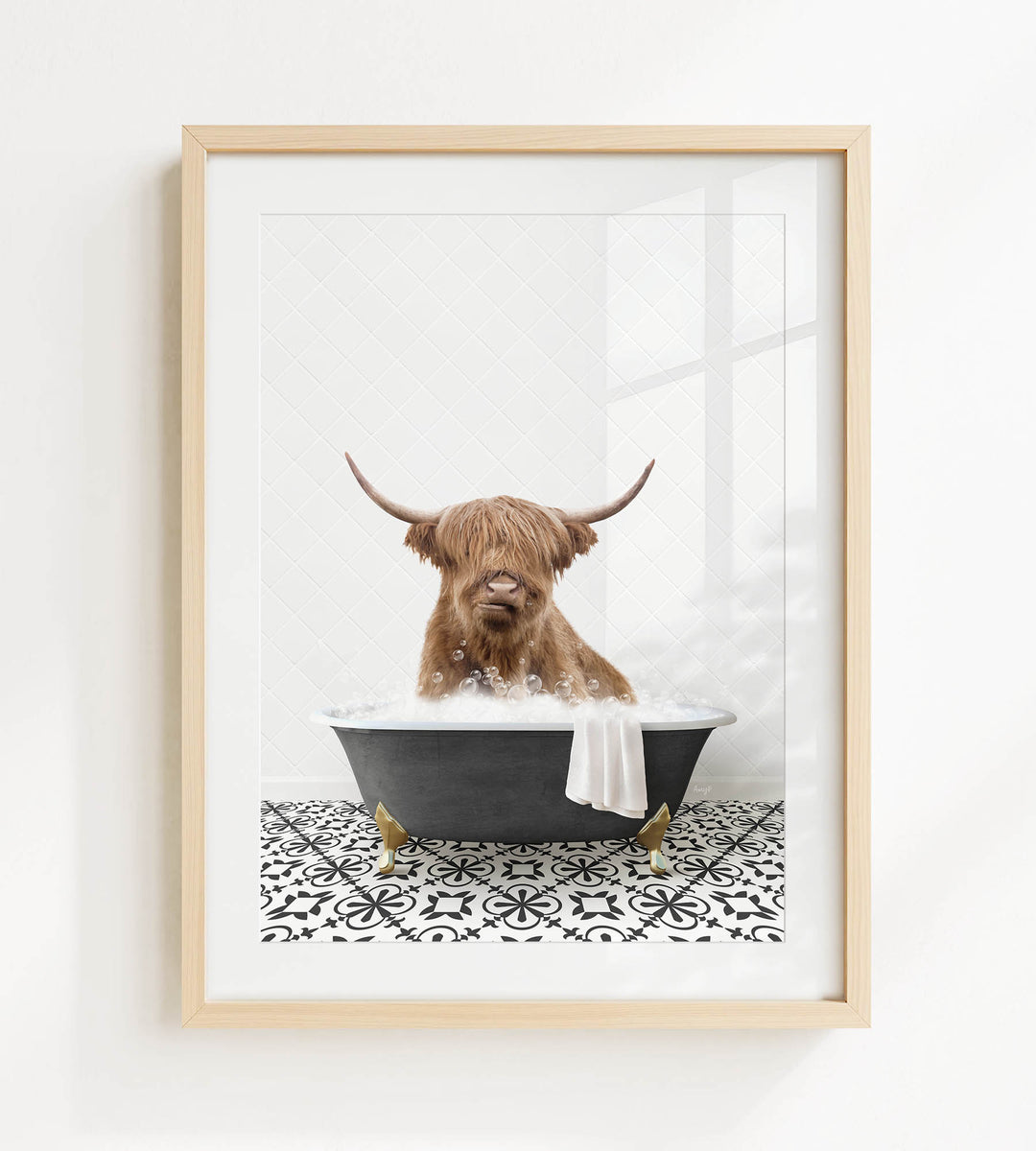 A brown cow with long horns is sitting in a black bathtub filled with water, surrounded by a black and white patterned floor.