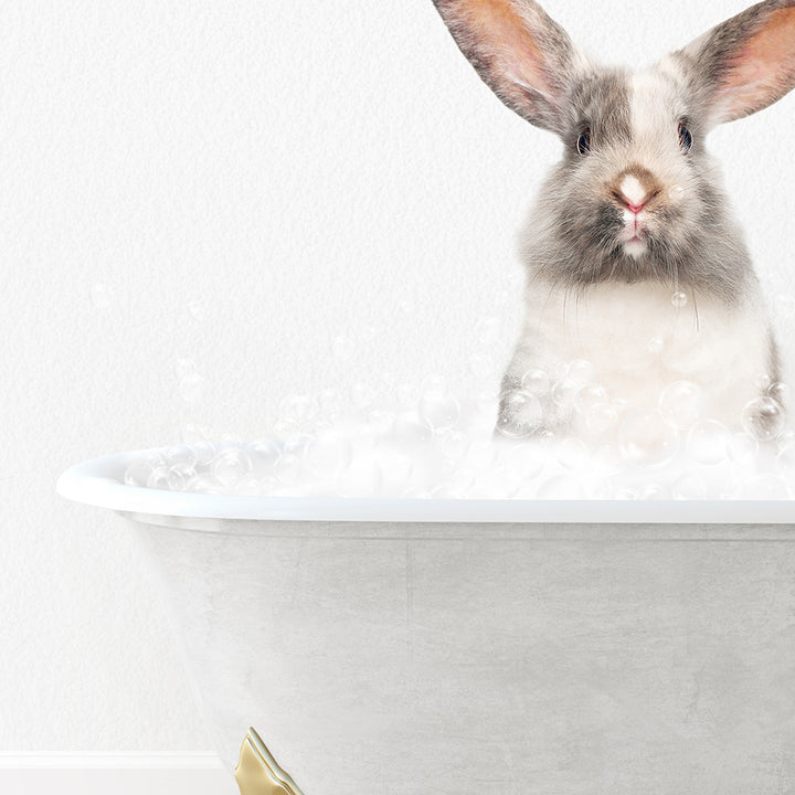 a rabbit sitting in a bathtub with bubbles