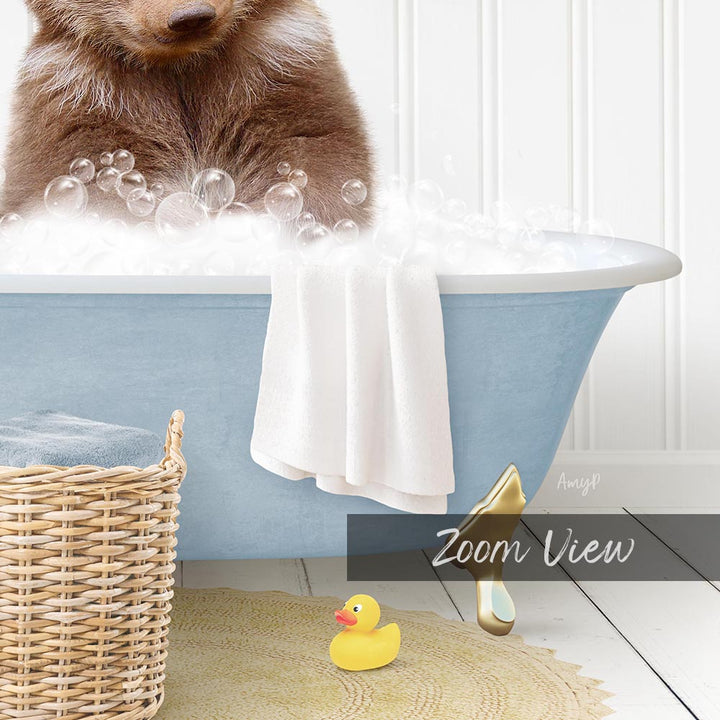 A brown bear is sitting in a blue bathtub filled with bubbles, surrounded by a white towel, a yellow rubber duck, and a wicker basket.