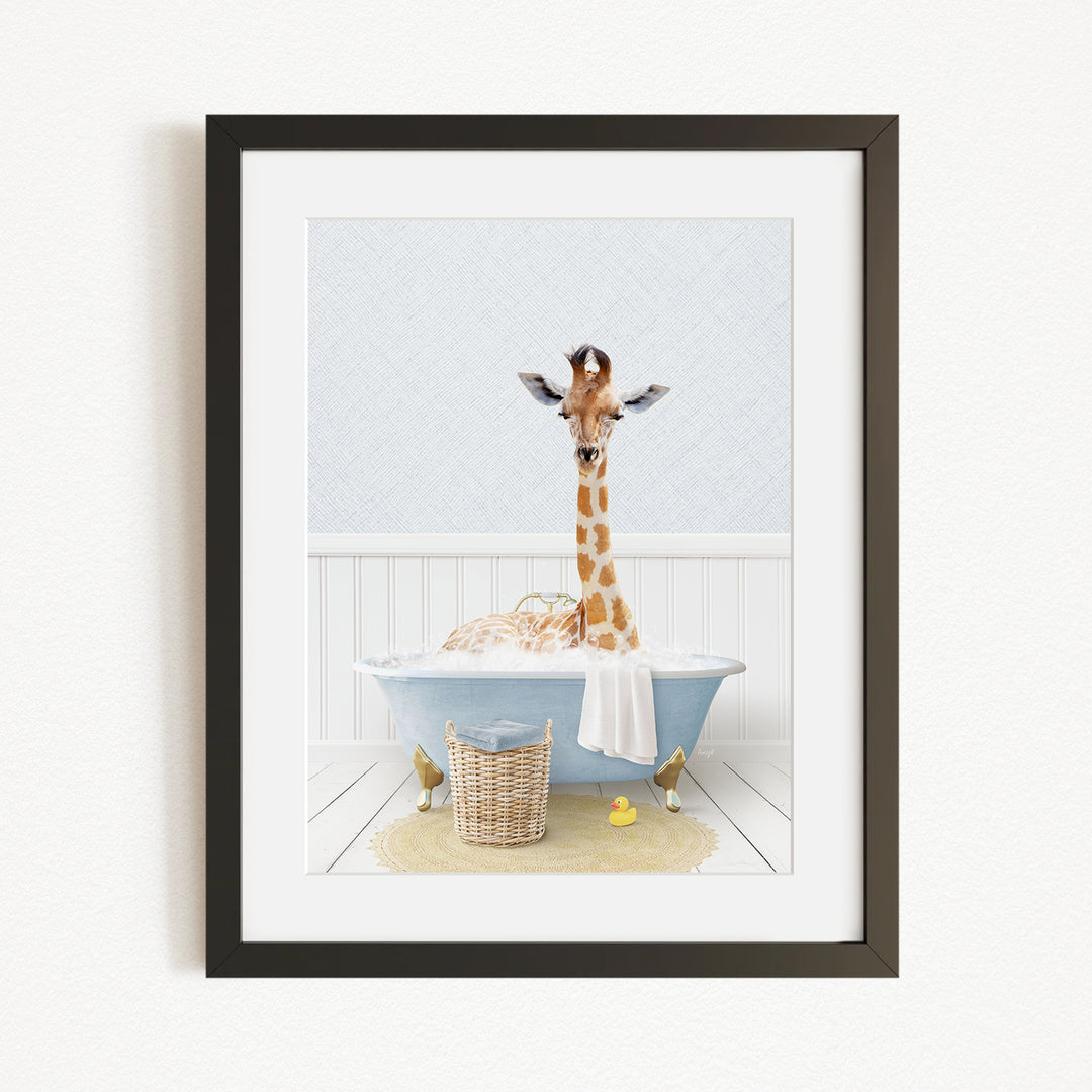 A giraffe standing in a blue bathtub filled with bubbles, surrounded by a yellow rubber duck and a basket.
