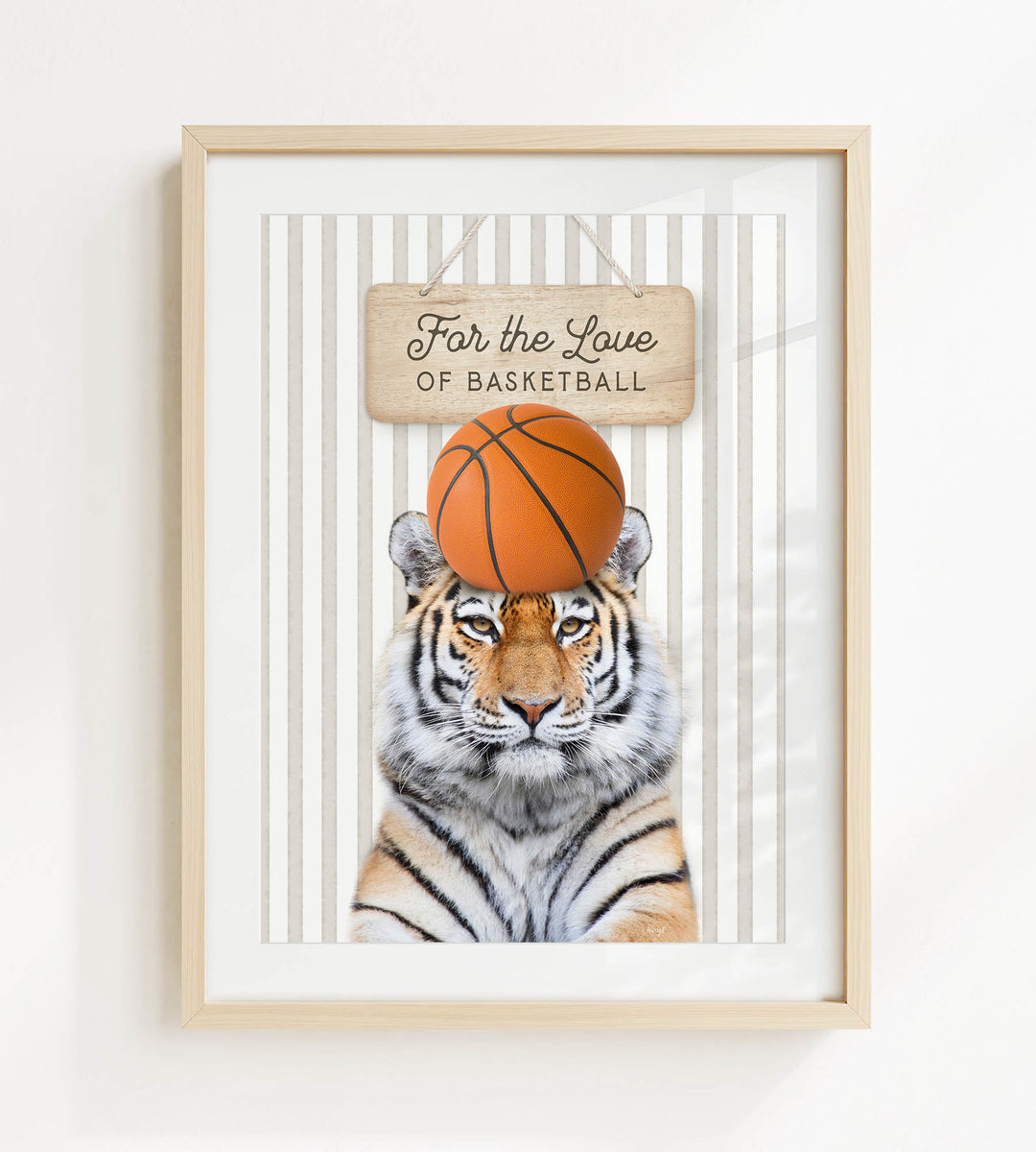 A framed image of a tiger with a basketball on its head, accompanied by a wooden sign that reads "For the Love of Basketball".