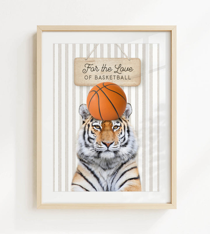 A framed image of a tiger with a basketball on its head, accompanied by a wooden sign that reads "For the Love of Basketball".