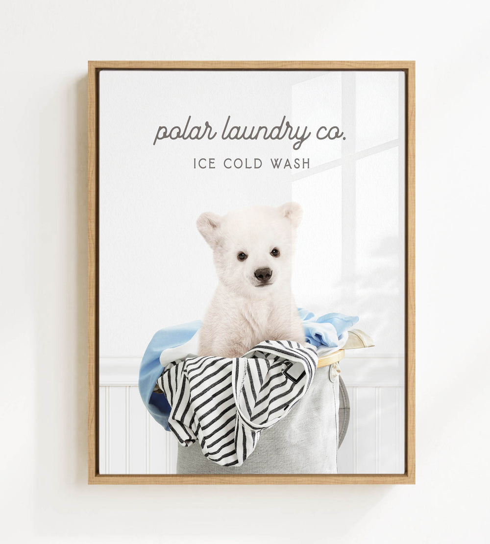 A white polar bear sitting in a laundry basket filled with clothes, with the text "ice cold wash" above the image.