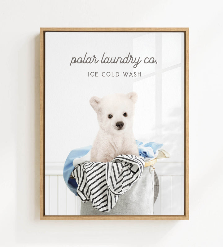 A white polar bear sitting in a laundry basket filled with clothes, with the text "ice cold wash" above the image.