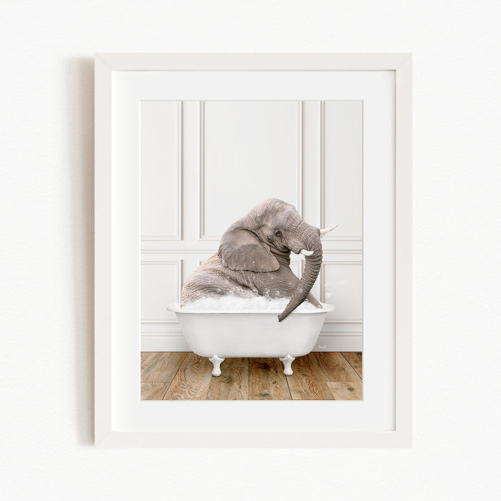 A gray elephant is sitting in a white bathtub, with its trunk raised and appearing to be enjoying the bath.