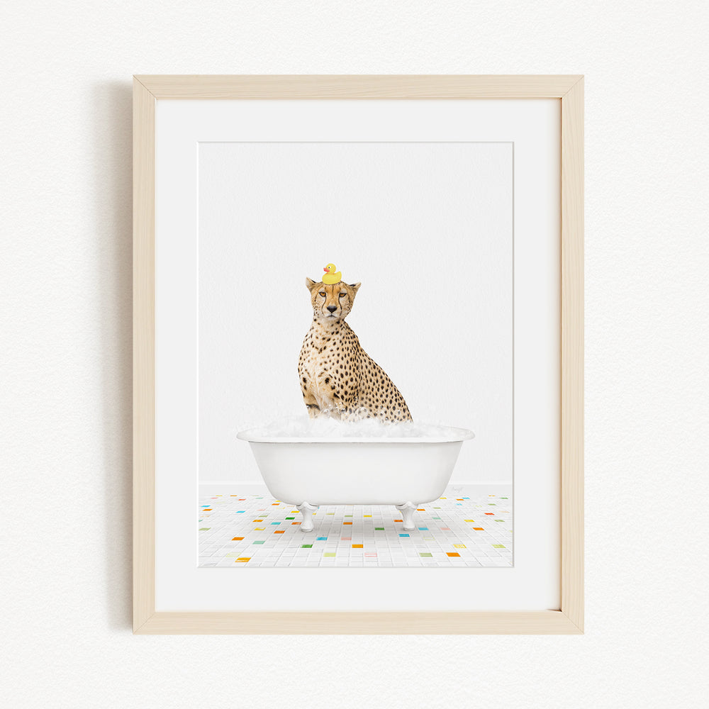 A cheetah wearing a yellow crown is sitting in a white bathtub filled with bubbles, surrounded by a colorful tiled floor.