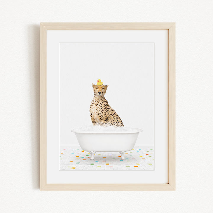 A cheetah wearing a yellow crown is sitting in a white bathtub filled with bubbles, surrounded by a colorful tiled floor.