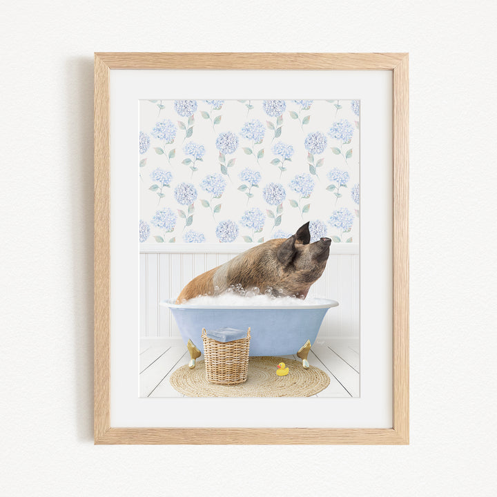 A brown pig sitting in a blue bathtub filled with bubbles, surrounded by a white floral pattern on the wall behind it.