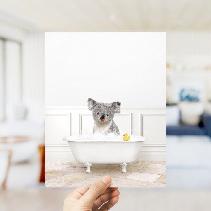 A koala sitting in a bathtub filled with bubbles, with a rubber duck floating nearby.