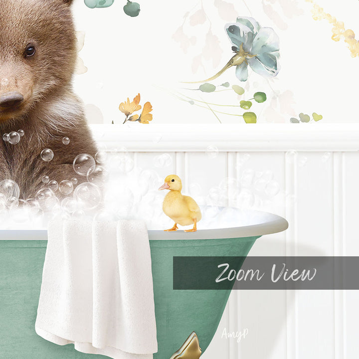 A brown bear is sitting in a bathtub filled with bubbles, with a yellow duck standing on the edge of the tub.