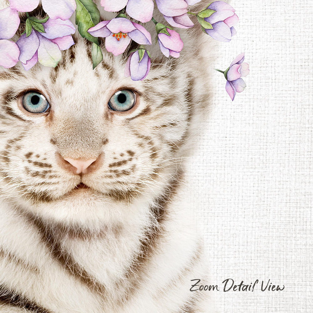 A close-up portrait of a white tiger cat with striking blue eyes, adorned with a floral headpiece of purple flowers.