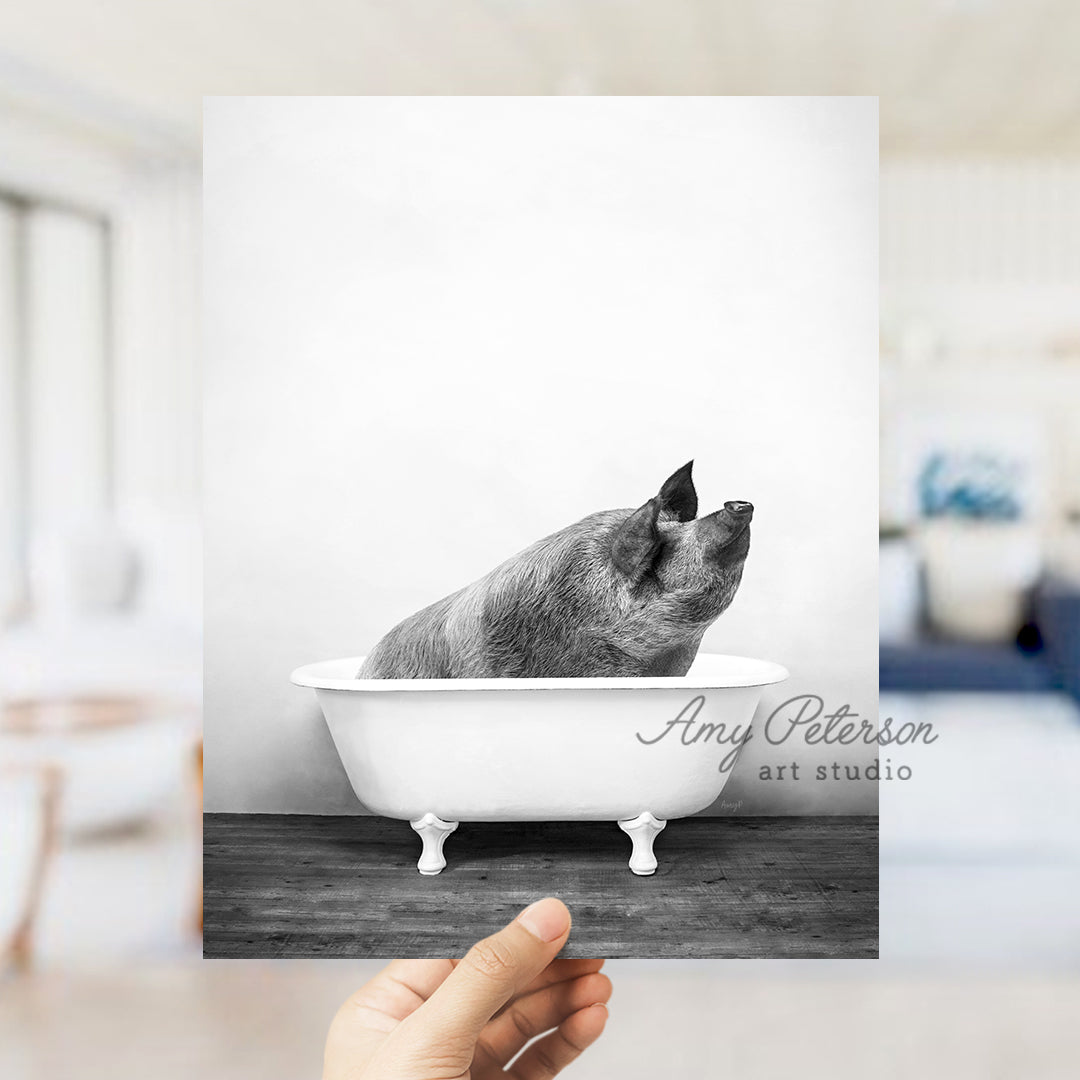 a black and white photo of a pig in a bathtub