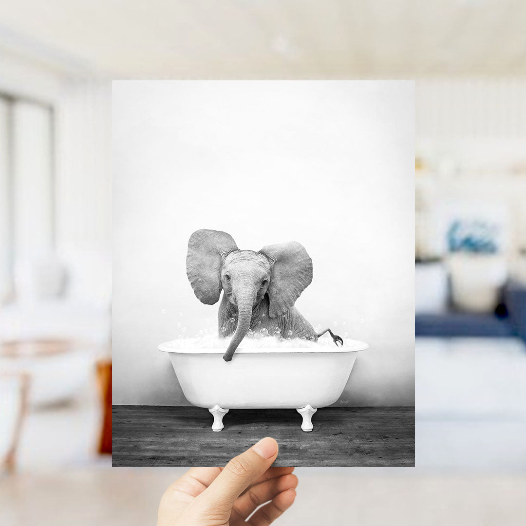 A small elephant sitting in a bathtub filled with water, appearing to enjoy the bath.