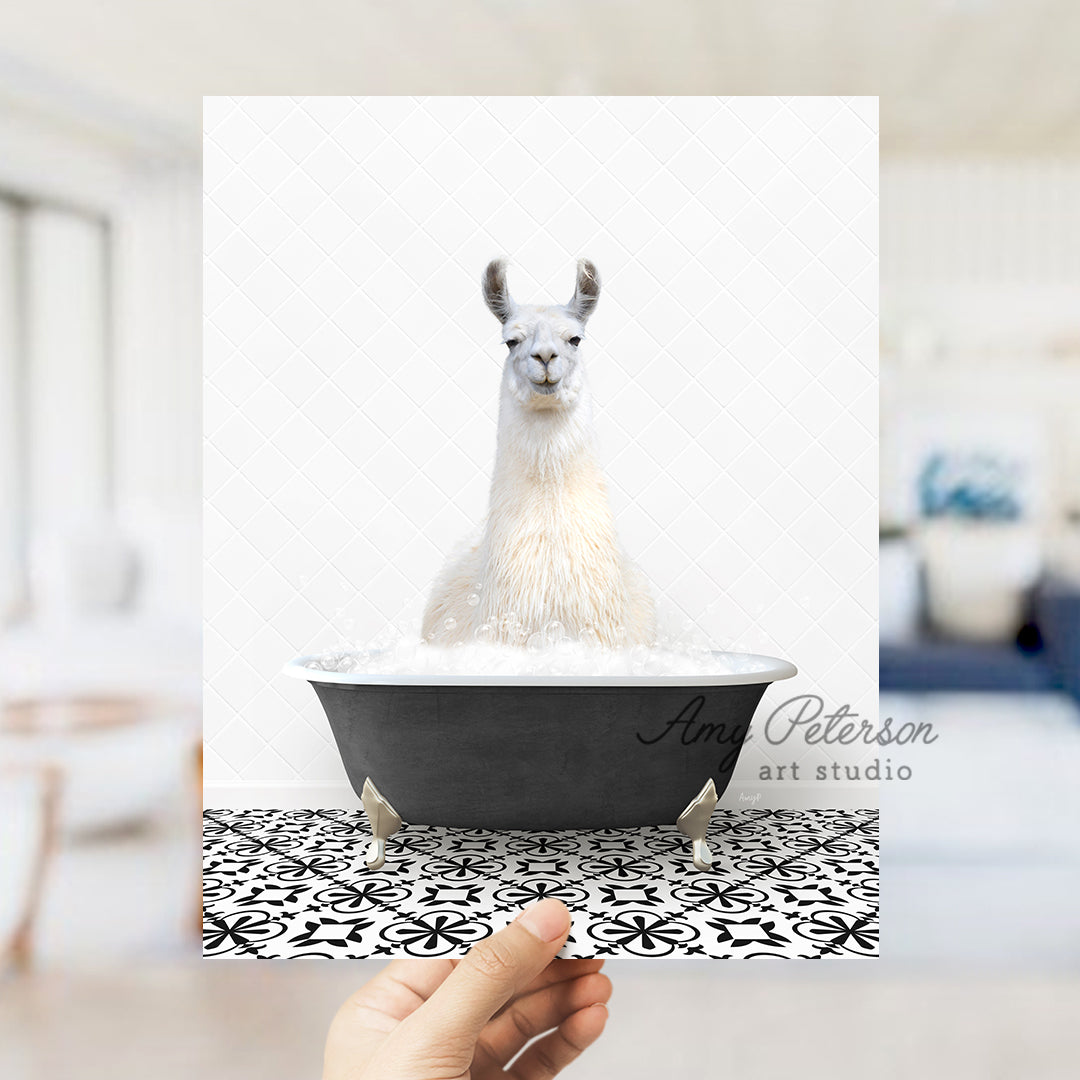 a llama in a bathtub with a hand holding it