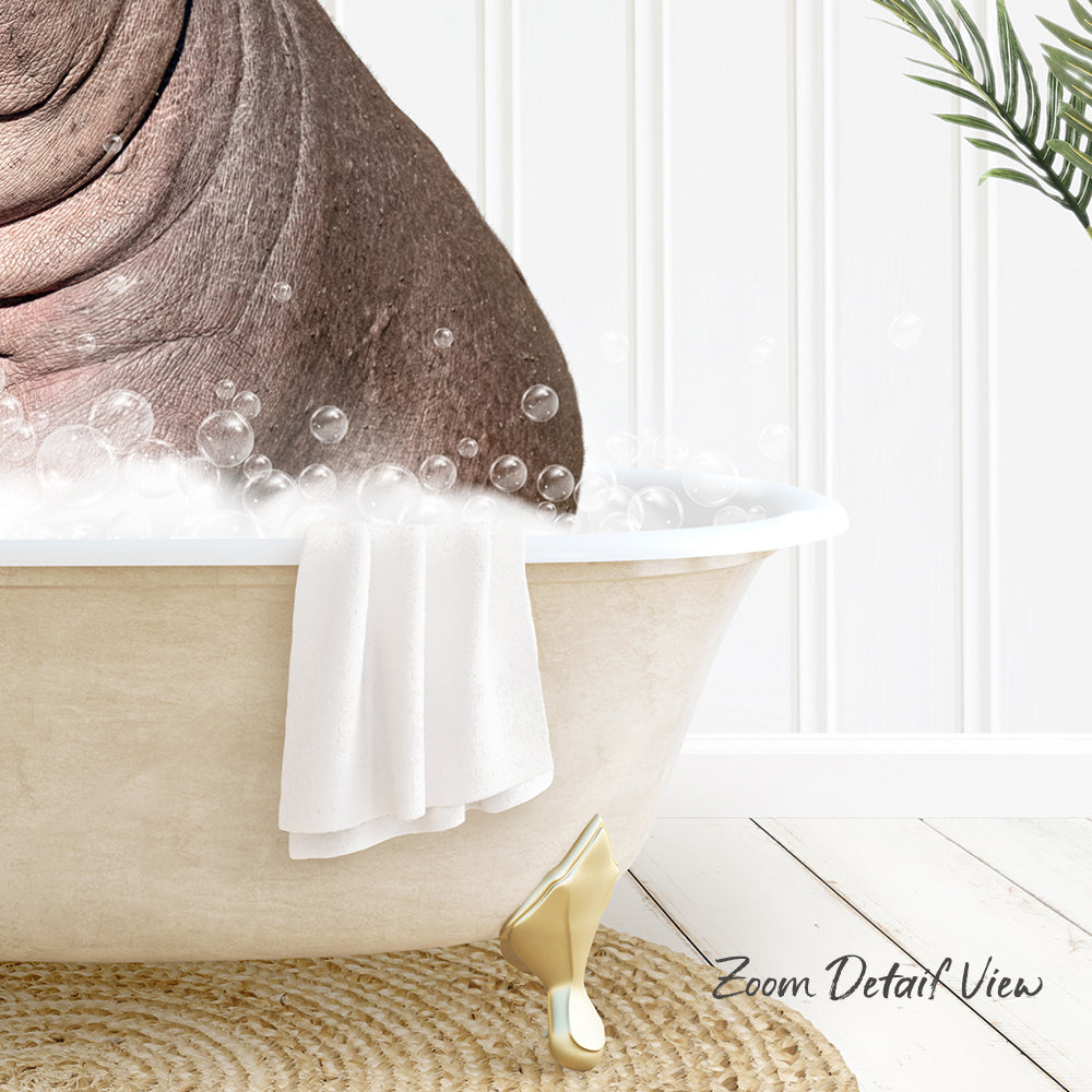 A bathtub filled with bubbles, with a towel hanging on the side and a plant in the background.