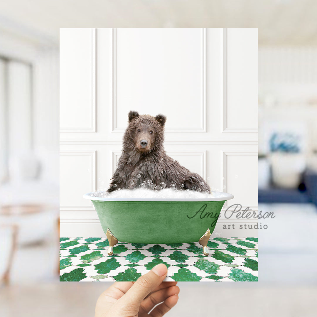 a hand holding a card with a bear in a bathtub