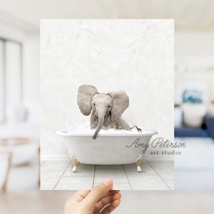 a hand holding up a card with an elephant in a bathtub