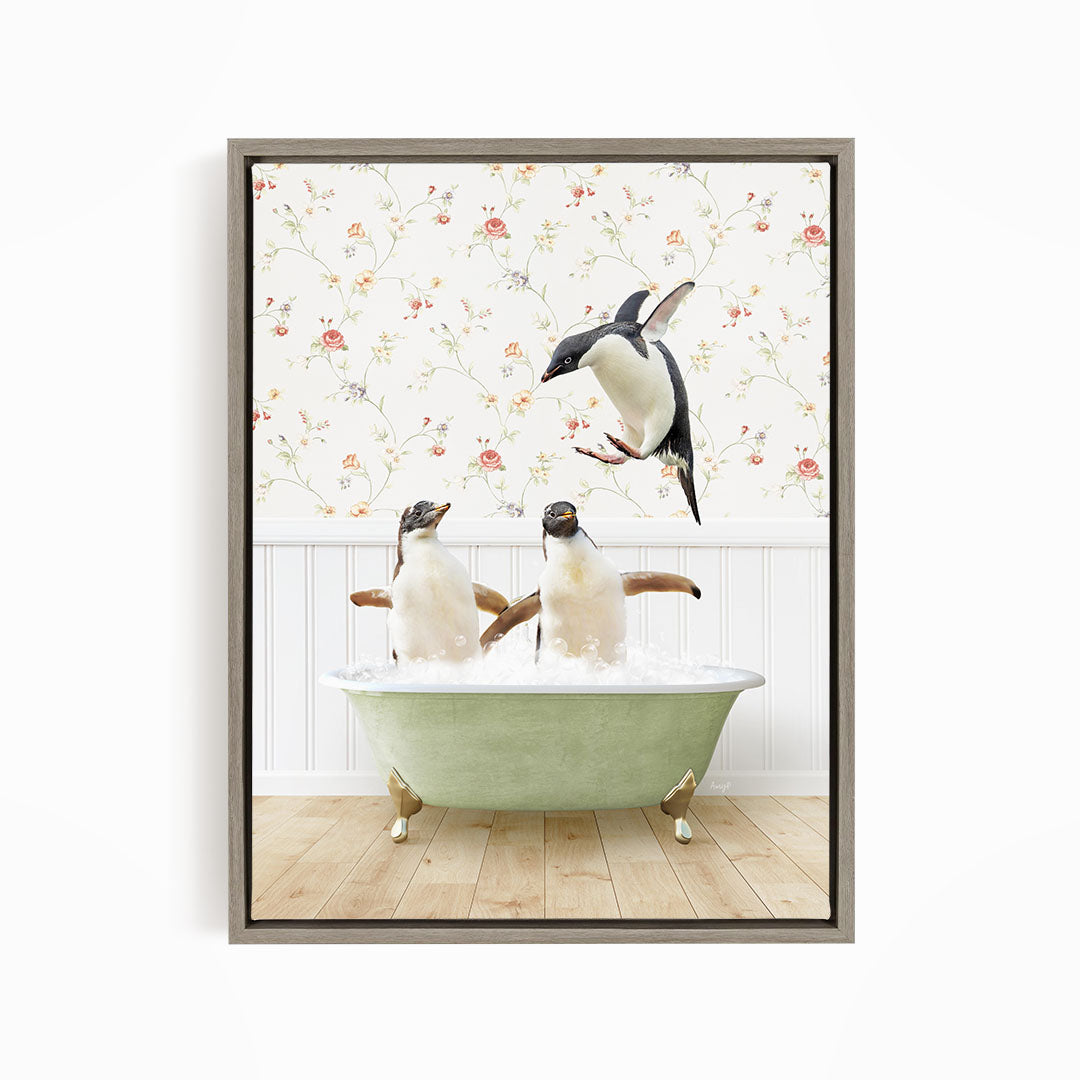 A framed image depicting two penguins sitting in a green bathtub, with one penguin flying towards the other in mid-air.