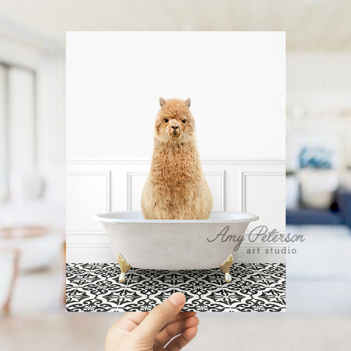 a hand holding a card with a picture of a llama in a bathtub