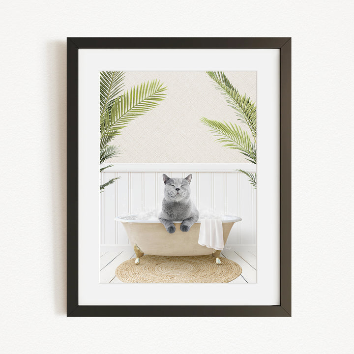 A gray cat sitting in a white bathtub, surrounded by green plants, creating a serene and relaxing atmosphere.