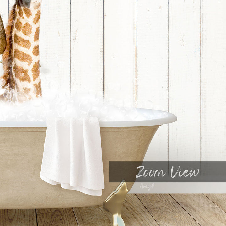 A bathtub filled with water and bubbles, with a towel hanging on the side and a giraffe figurine on the edge of the tub.