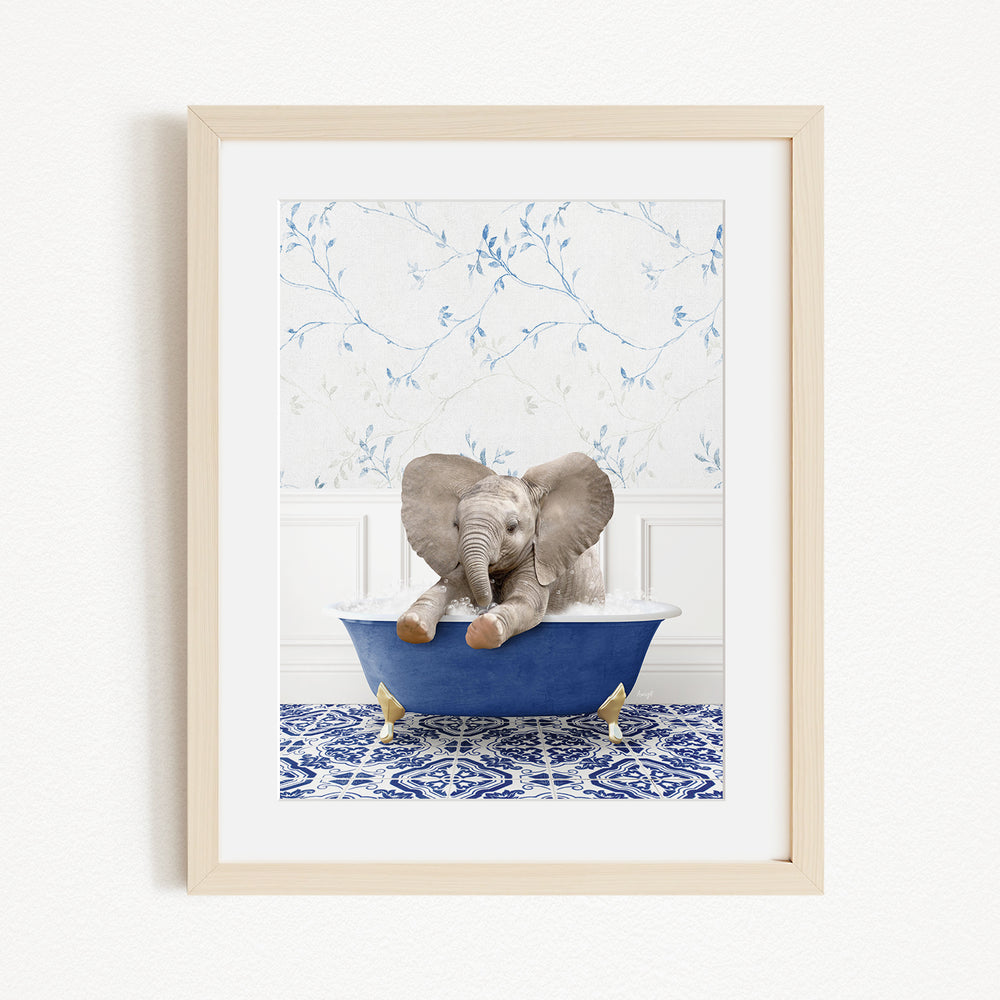 A baby elephant sitting in a blue bathtub, surrounded by a blue and white patterned rug and a white wall with blue floral wallpaper.