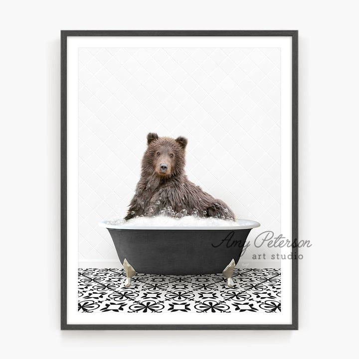 a black and white photo of a bear in a bathtub