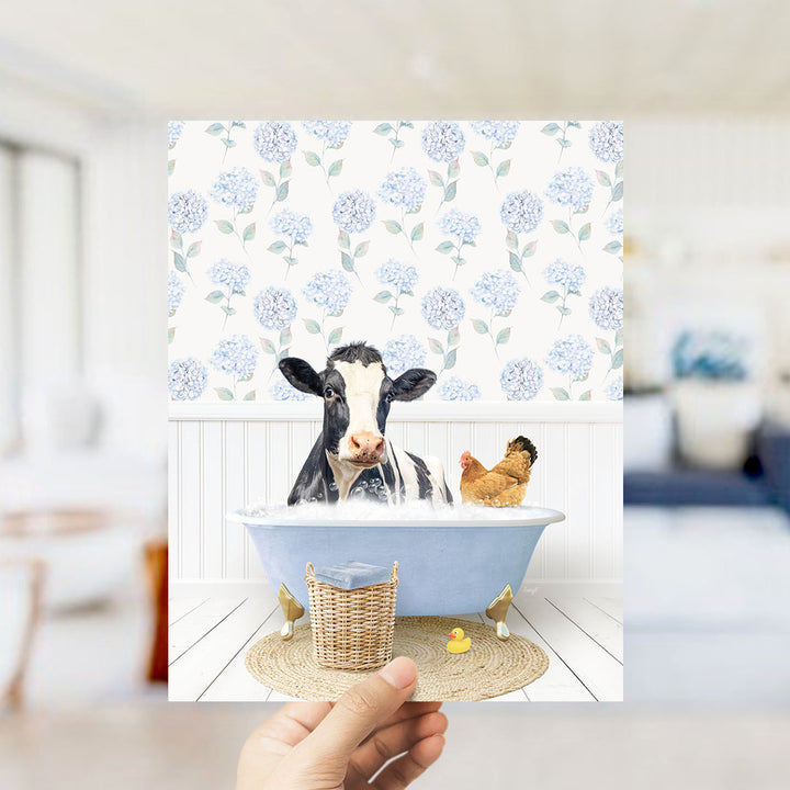 A cow and a chicken are sitting in a bathtub filled with water, surrounded by a blue and white floral pattern.