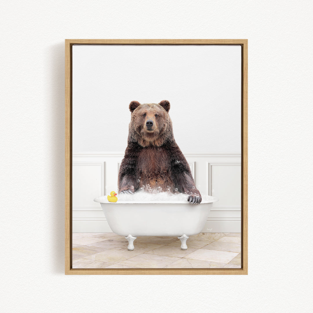 A brown bear sitting in a white bathtub, with a yellow rubber duck floating in the water.