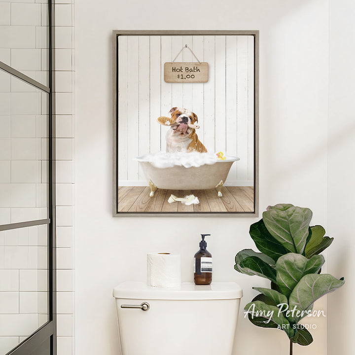 A framed image of a dog sitting in a bathtub, with a sign above it that says "Hot Bath is $10". The image also features a toilet and a potted plant in the bathroom.