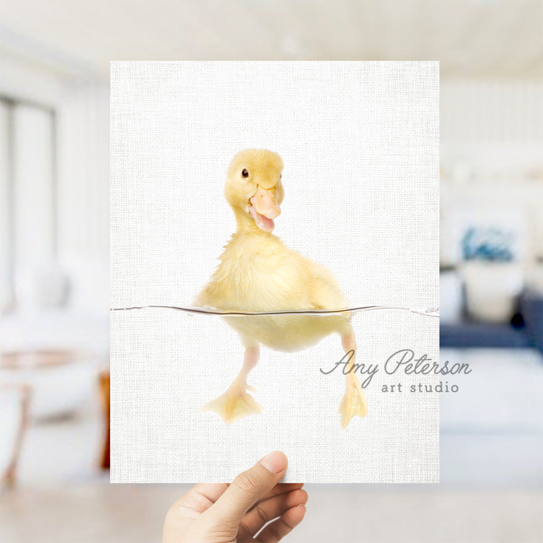 a person holding up a card with a picture of a duck