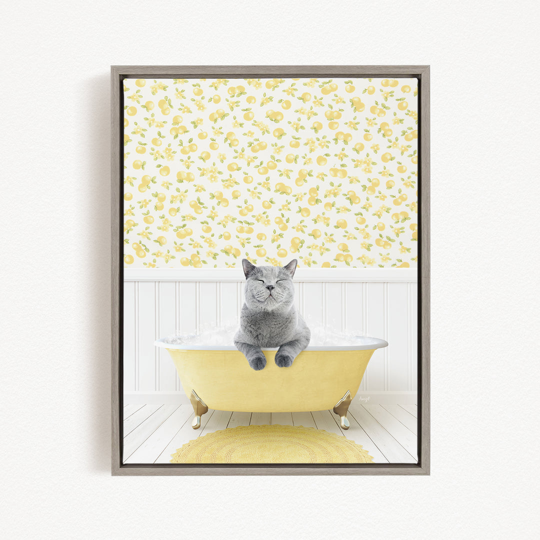 A gray cat sitting in a yellow bathtub, surrounded by a yellow and white floral pattern on the walls.