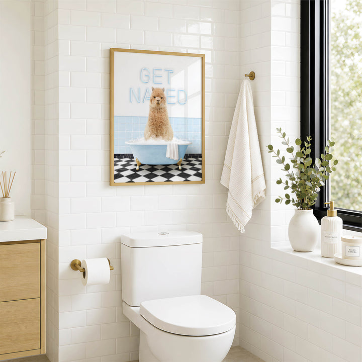 A bathroom with a white toilet, a framed poster of a dog in a bathtub, and a window with greenery on the sill.
