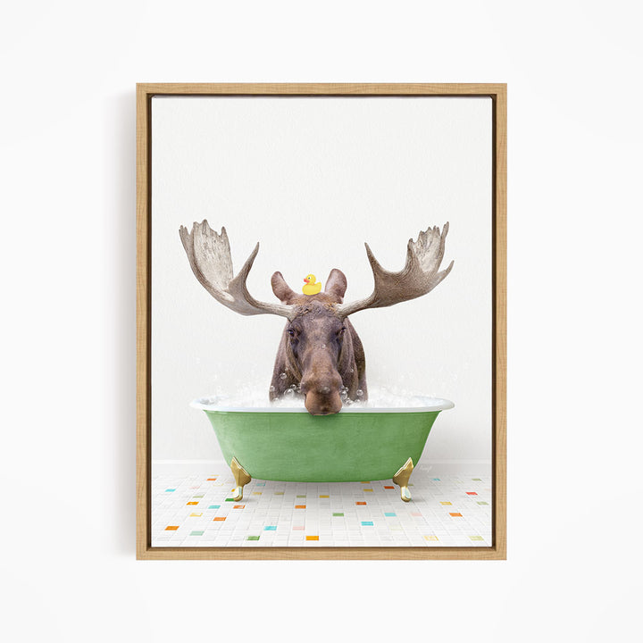 A moose with large antlers is sitting in a green bathtub, with a rubber duck floating on its head.