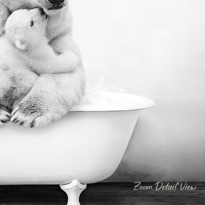 A black and white image showing a mother polar bear and her cub sitting together in a bathtub, with bubbles rising around them.