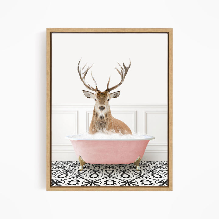 A deer with large antlers is sitting in a pink bathtub filled with bubbles, creating a whimsical and unexpected scene.