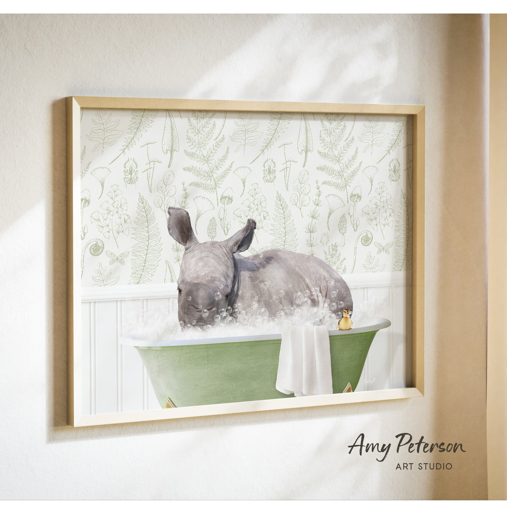 A rhinoceros is sitting in a green bathtub filled with bubbles, surrounded by a floral patterned wall.