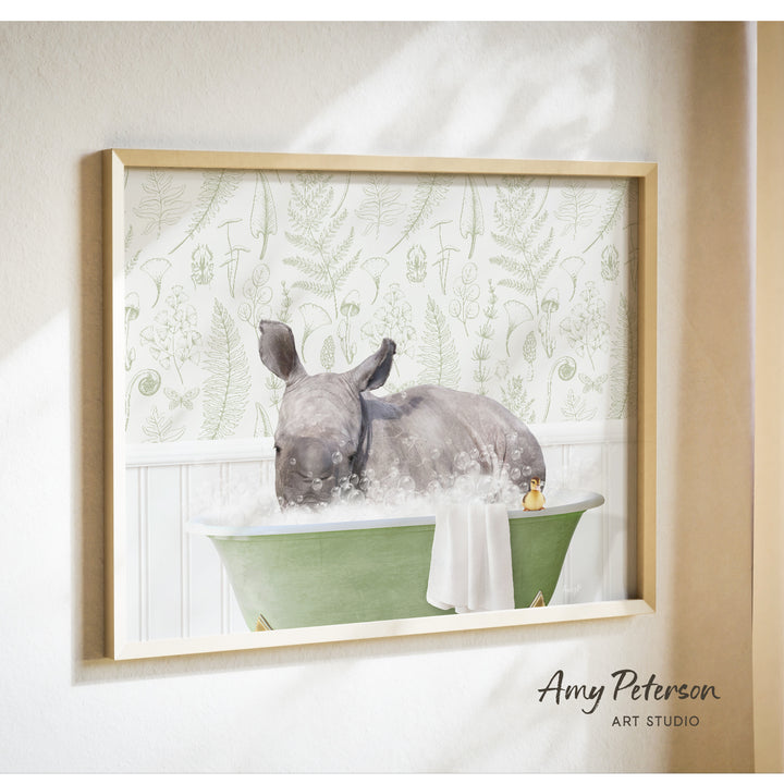 A rhinoceros is sitting in a green bathtub filled with bubbles, surrounded by a floral patterned wall.