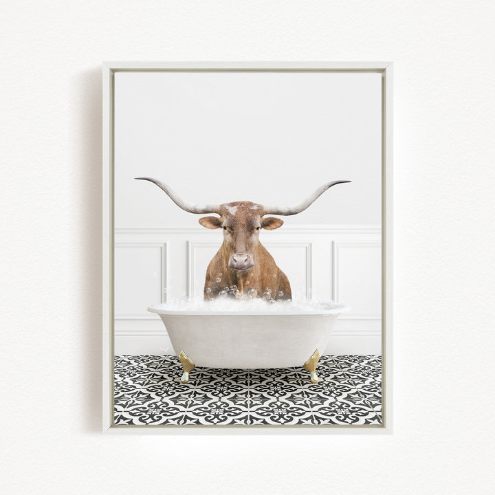A brown bull with long horns is sitting in a white bathtub filled with water, creating a whimsical and humorous scene.