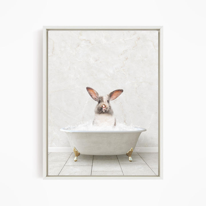 A white rabbit sitting in a white bathtub filled with water, looking directly at the camera.