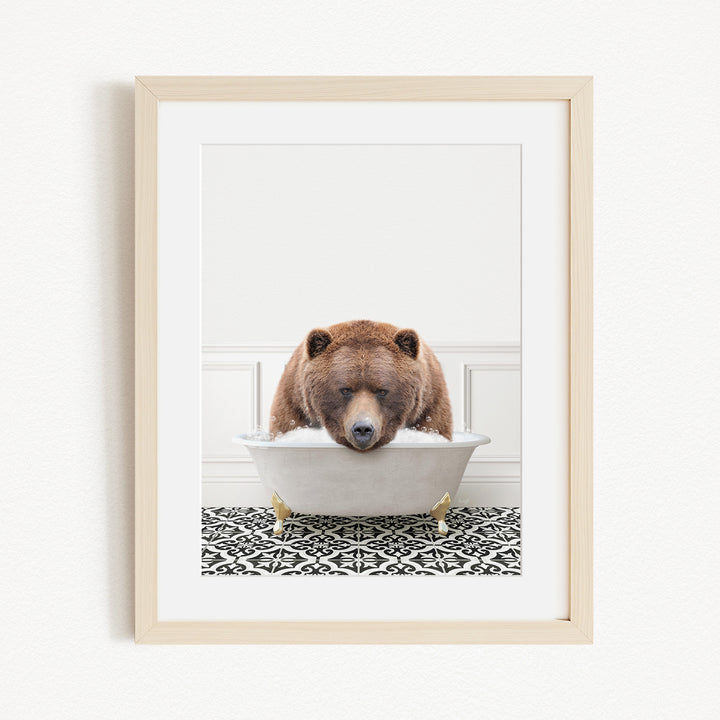 A brown bear is sitting in a white bathtub filled with water, appearing to be enjoying a relaxing bath.