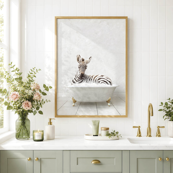 a bathroom with a framed picture of a zebra sitting in a bathtub, surrounded by flowers and candles.