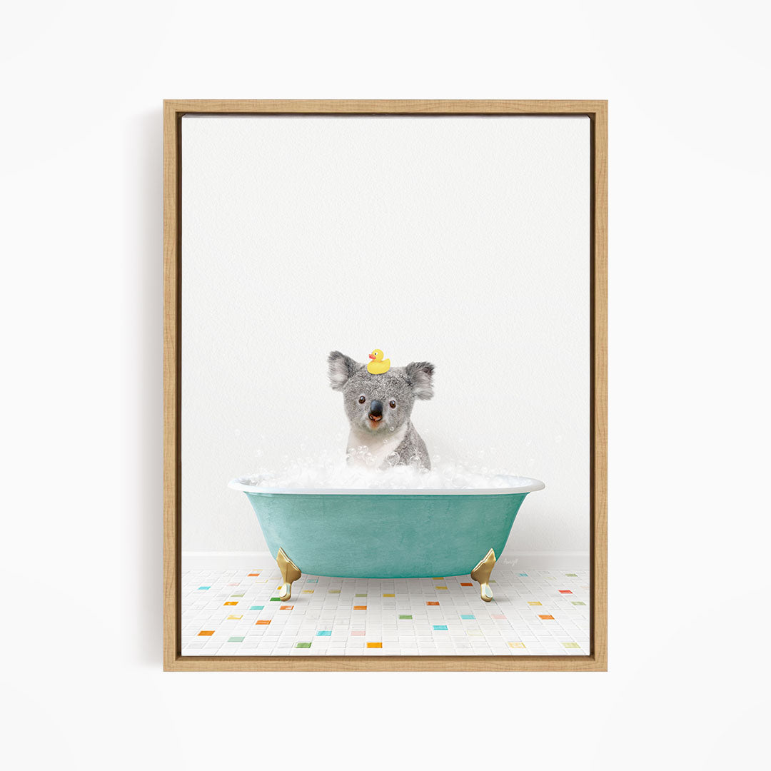 A koala bear sitting in a blue bathtub filled with bubbles, wearing a yellow rubber duck hat.